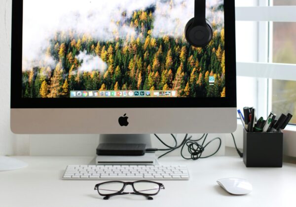 Free Stylish home office workspace featuring a computer setup with accessories. Stock Photo