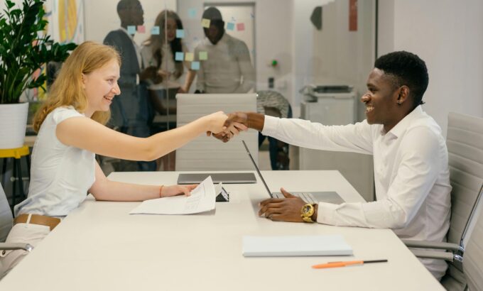 pexels-mikhail-nilov-9301879-scaled.jpg Free Business professionals completing a successful deal with a handshake in a modern office setting. Stock Photo