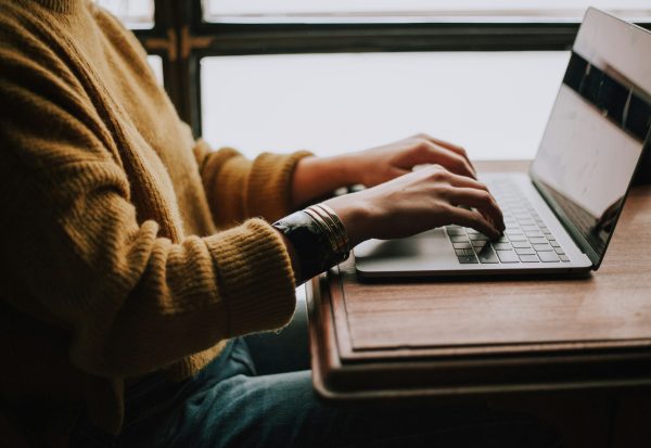person sitting front of laptop